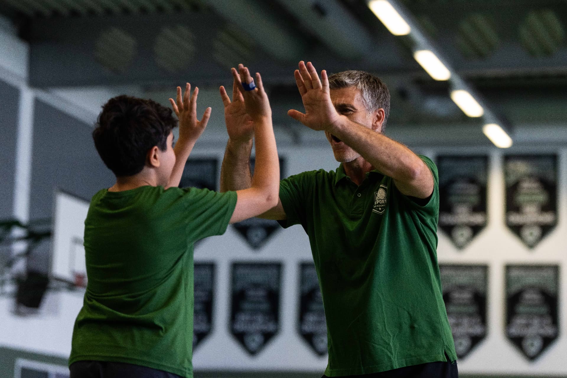 WeSports Academy coach giving a camper a high five